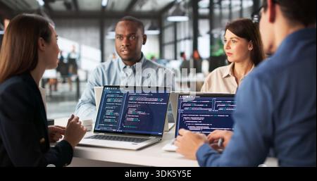 Software Engineer Leading A Diverse Team In Office Collaboration Meeting. Stock Photo