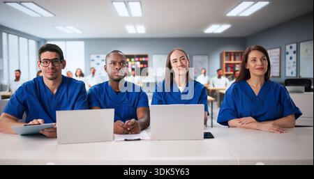Diverse Group Of College Students In Classroom Using Laptops For Medicine. Stock Photo