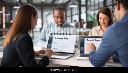 Business Meeting To Discuss Annual Report With Diverse Team Members. Stock Photo