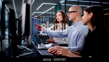 Agile Team Of Diverse Professionals Managing Tasks With Kanban Board. Stock Photo