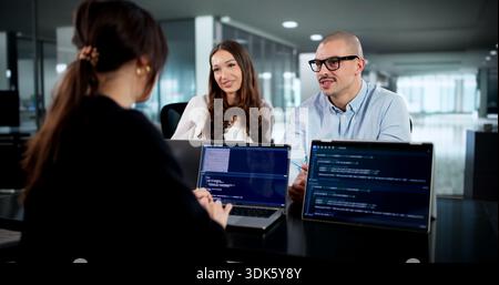 Innovative Software Engineers Collaborate In Diverse Office Environment Developing Codes. Stock Photo
