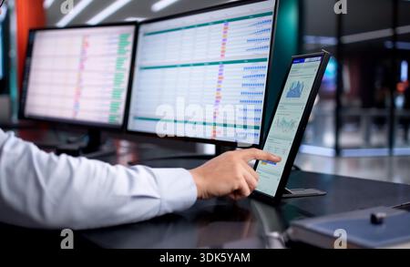 Analyzing Business Data On Computer, Financial Advisor Reviews Spreadsheet Analysis. Stock Photo