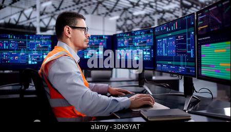 Hispanic Engineer Operating Scada System For Efficient Industrial Production Line Stock Photo