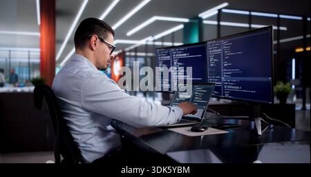 Busy Software Engineer Coding In Office, Developing Web Applications For Company. Stock Photo