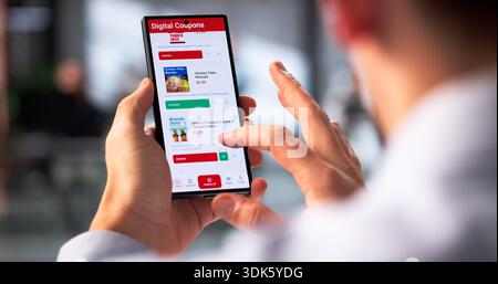 Tech-Savvy Businessman Scrolling Through Online Coupons On His Smartphone Stock Photo