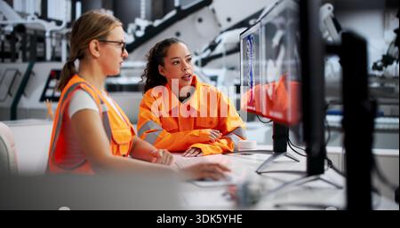 Women Engineers Developing Automobile Gearbox Using 3D CAD Software Stock Photo