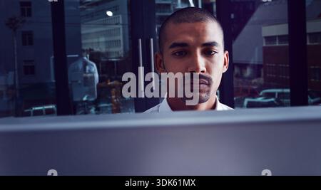 Night, man and developer in office with computer, programming and cloud computing for cybersecurity. Late, person and coding in workplace with desktop Stock Photo