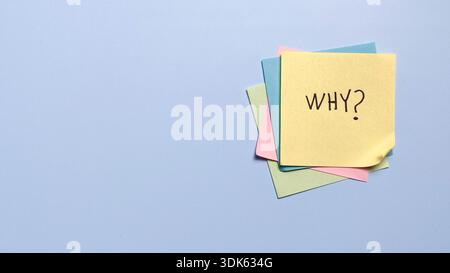 Stack of colorful sticky notes with handwritten why text for brainstorming and creative problem solving Stock Photo
