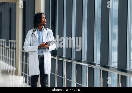 Young male black doctor is in the corridor. Stock Photo