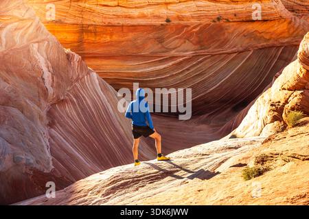 Dramatic Textures Surrounding Lone Desert Hiker at The Wave Stock Photo