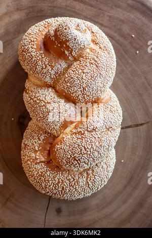A twisted loaf of challah bread covered in sesame seeds Stock Photo
