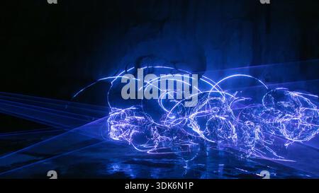 Abstract blue light trails forming digital energy waves on dark Stock Photo