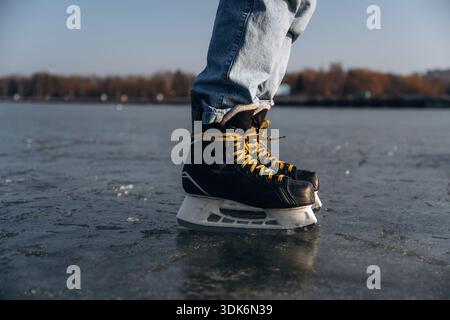 On the surface. Close up view of man that is on ice with skates in winter. Stock Photo