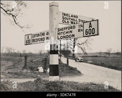 A finger post road sign on the A600 between Bedford and Shefford, showing the turning for Ireland, Southill, Central Bedfordshire, 1940-1960. Stock Photo