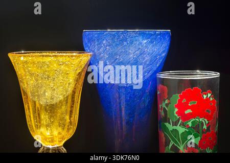 Coloured glass, with two drinking glasses and one blue vase Stock Photo