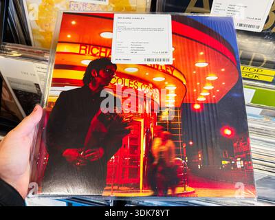 Manchester, UK - January 21, 2026: A glossy vinyl album cover featuring Richard Hawley in a red neon city at night. Coles Corner Stock Photo