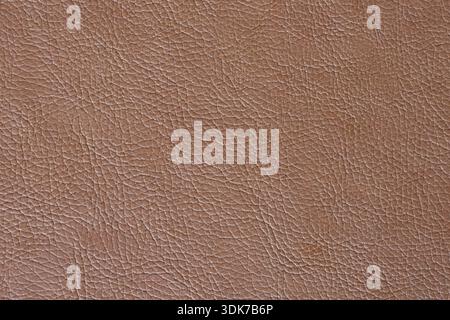 Full Frame Texture of Light Brown Faux Leather Material: Close-up of a Grained Synthetic Surface with Natural Leather Pattern and Soft Earthy Tones Stock Photo