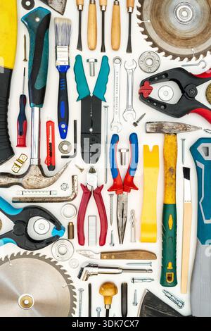 Flat lay of new and used hand tools on white background. Large collection of various tools and bits arranged on white. Stock Photo