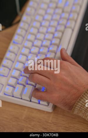 Person working on 3D animation at desk with graphics tablet and mechanical keyboard Stock Photo