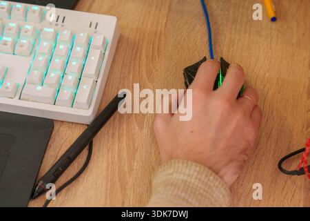 Person working on 3D animation at desk with graphics tablet and mechanical keyboard Stock Photo