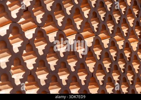Decorative wall made of patterned hollow terracotta bricks, designed as a screen or partition allowing natural ventilation and light while providing s Stock Photo