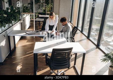 Project plan, working. Man and woman are indoors in modern building. Stock Photo