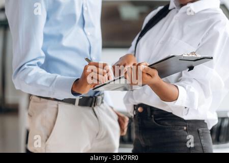 Man with woman are making business, signing documents, close up view. Stock Photo