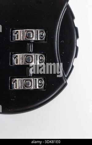 Close-up of black combination lock with code on white background. Stock Photo