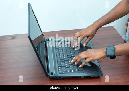 A person working or browsing on a laptop, representing modern technology, digital work, and productivity Stock Photo
