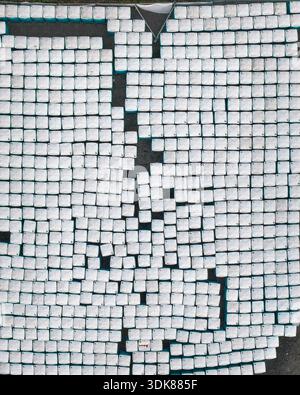 Aerial view of a geometric pattern of white cubes against a dark backdrop creates an abstract, minimalist scene, Müllenbach, Rhineland-Palatinate, Ger Stock Photo