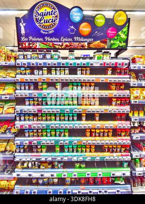 Supermarket display of bottles of herbs and spices - Auchan supermarket, Ligueil, Indre-et-Loire (37), France. Stock Photo
