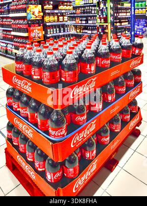 Supermarket promo display of bottles of Coca-Cola soft drink - Auchan supermarket, Ligueil, Indre-et-Loire (37), France. Stock Photo