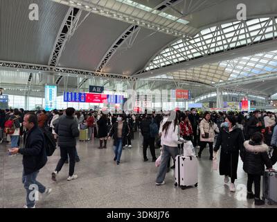 Guangzhou, China - Jan 28, 2024: Guangzhou Railway Station interior with many travelers and departure boards visible. Stock Photo