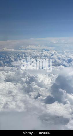 Cloudscape viewed from an airplane window during flight over Central America. Stock Photo