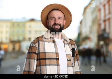 Man with hidden spy camera in his pocket on city street outdoors Stock Photo