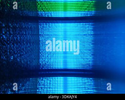 Close up detail of a digital screen with flowing blue neon light artifacts, representing cybersecurity or blockchain technology concepts. Stock Photo