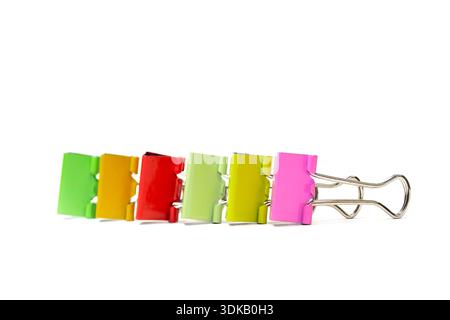 Colorful binder clips creating a neat line on a white background Stock Photo