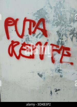 Graffiti reading “puta renfe” criticizing Spanish railway company on a wall in Sabadell, Spain Stock Photo