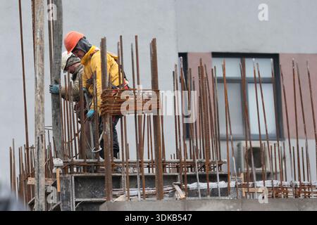 Bucharest, Romania - January 30, 2026: Romanian construction workers on a construction site. Stock Photo