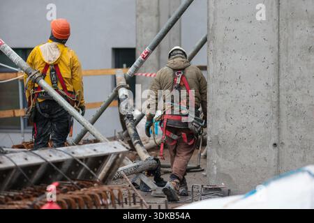 Bucharest, Romania - January 30, 2026: Romanian construction workers on a construction site. Stock Photo