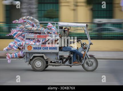 Hanoï, Vietnam. January 31, 2026. A three-wheeled motorized vehicle transports wrapped peach blossom trees through Hanoi traffic, with motion blur capturing the speed. These plants provide protection against bad spirits during the Tet festival (Lunar New Year), the Southeast Asian country's most important celebration. Starting today, the Vietnamese capital city will host flower markets until February 15. As Vietnamese people prepare to celebrate, warm clothes are coming out as northern Vietnam is hit by an intense cold wave with very low temperatures. Credit: Kevin Izorce/Ģ����ý Live News Stock Photo