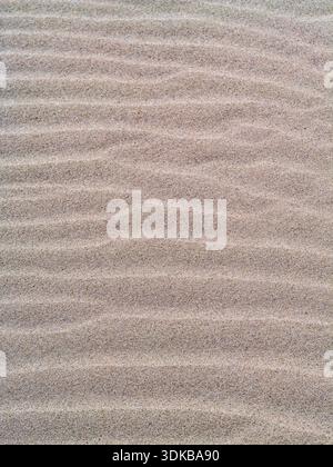 Beautiful wave pattern in the sand on the beach, well suited as a background. Taken on Djerba. Djerba is a Tunisian island. Stock Photo