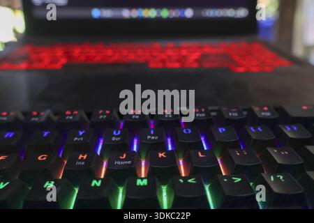Intense focus on gaming keyboard with multicolor RGB lighting. close up on computer setup with modern technology and equipment for entertainment and e Stock Photo