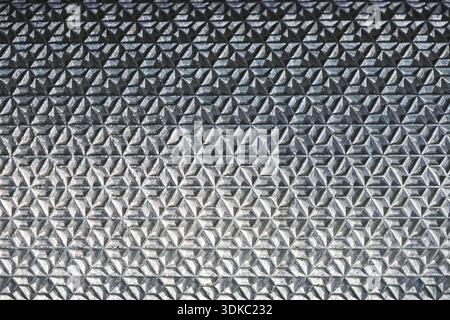Close up abstract geometric background texture of gray sleeping pad. This modern mat pattern provides comfort and insulation for outdoor camping and r Stock Photo