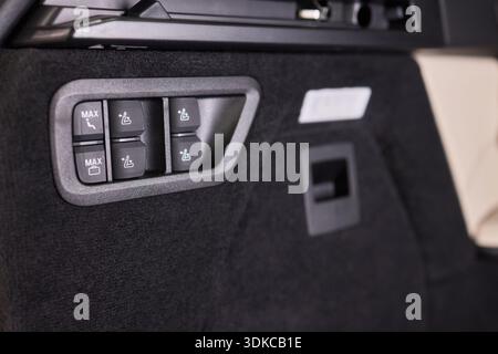 Vehicle dashboard with functional switches and lights. Detailed image of vehicle dashboard controls highlighting tactile switches and trim for Stock Photo