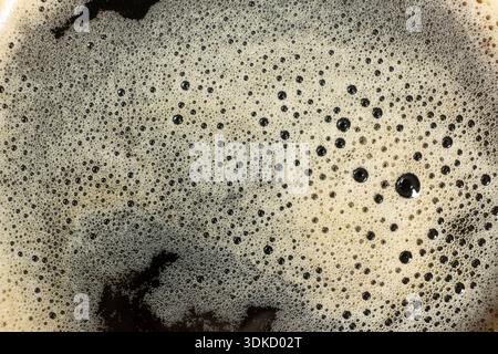 Macro texture of golden coffee foam with many small bubbles Stock Photo