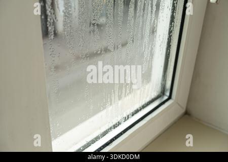 Close up of misted window glass with water streaks and droplets. Stock Photo