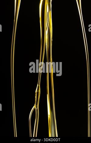 Abstract oil splashes and drips isolated on black for luxury design. Stock Photo