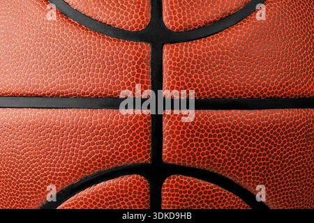 Detailed macro shot showing the texture of an orange basketball ball with black seams Stock Photo