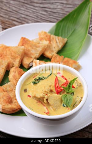 Thai-style Green Curry Chicken Served with Roti. Food photography for use in menus Stock Photo